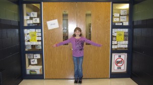 Kayla in front of the library doors. She helped color in all of the pictures taped to the windows on either side.